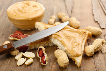 Fototapeta na wymiar Slices of bread with creamy peanut butter