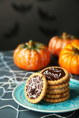 Naklejka na ściany i meble Tasty Halloween cookies on plate, on decorative spiderweb