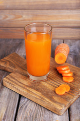 Glass of carrot juice and fresh carrot