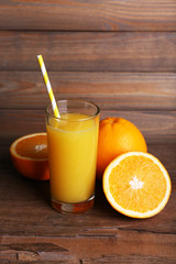 Glass of orange juice and fresh oranges