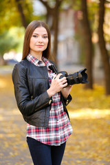 Beautiful young photography take photos outdoors in park