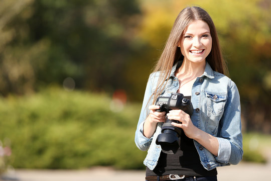 Beautiful young photography take photos outdoors in park