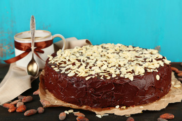 Tasty chocolate cake with almond, on old wooden table