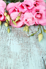 Beautiful eustoma flowers on wooden background