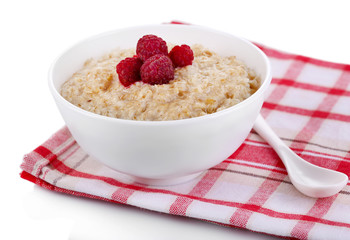 Tasty oatmeal with berries on napkin isolated on white