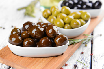 Different marinated olives on table close-up