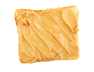 Bread slice with creamy peanut butter, isolated on white