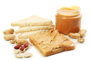 Creamy peanut butter and bread slices, isolated on white