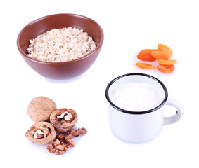 Bowl of oatmeal, mug of milk, dried apricots and walnuts