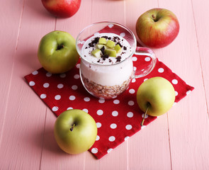 Oatmeal with yogurt in pitcher and apples