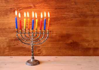 low key image of jewish holiday Hanukkah background with menorah