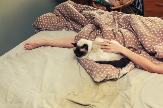 Woman and cat in bed