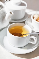 tea set and white cup with herbal tea