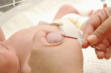 Doctor making blood test from newborn patient in hospital