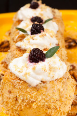 apple dessert with nuts, whipped cream and blackberry