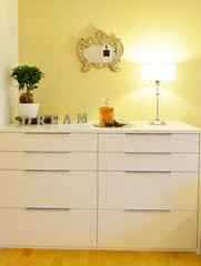 Chest drawer in the interior of a stylish bedroom