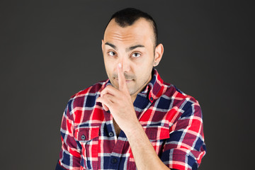 model isolated with finger on lips secret