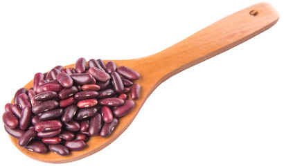 Red kidney beans on wooden spoon over white background