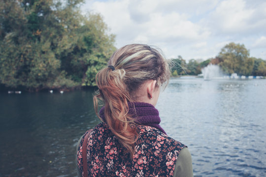 Woman looking at lake in a park