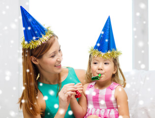 mother and daughter in party hats with favor horns