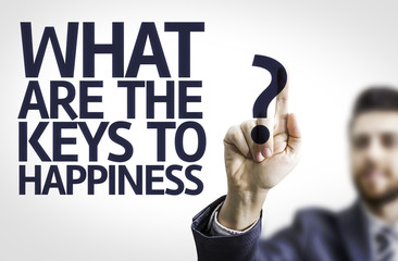 Business man pointing: What Are The Keys to Happiness?