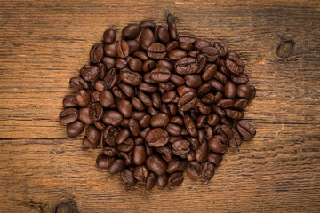 Coffee beans on grunge wooden background