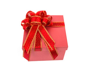 Red gift box with red and glod ribbon on white background