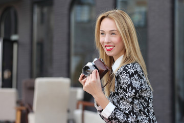 outdoor photo blonde girl with a camera