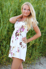 Fototapeta premium sexy young woman in dress in the grass