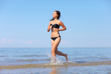 Fototapeta na wymiar woman running in the water