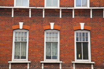 Fototapeta na wymiar windows and wall made of red brick