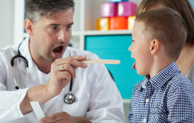 Obraz premium Pediatrist examinate boy's throat