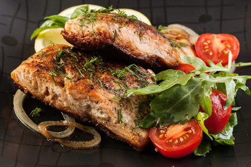 Fried salmon steak with vegetables
