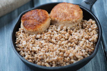 Buckwheat with meat cutlets, close-up, horizontal shot