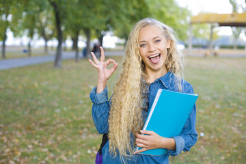 Beautiful student showing OK sign