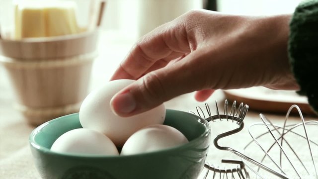 White eggs being picked up, Slow Motion