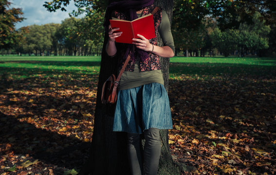 Young woman reading in the park