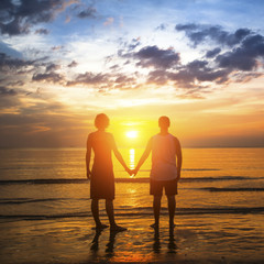 Young couple during honeymoon on a tropical beach.