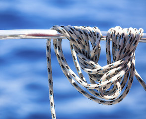 Ropes on the deck of sailboat hanging.