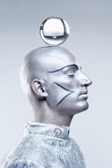 Magician with Glass Ball in Stage Makeup and Costume