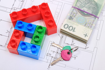House of colorful building blocks, keys and banknotes