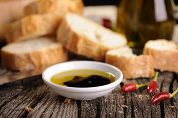 Fototapeta na wymiar Small bowl of olive oil and balsamic vinegar with dipping bread