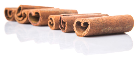 Cinnamon sticks over white background