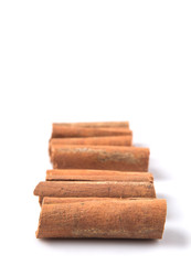 Cinnamon sticks over white background