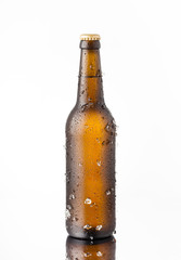 Bottle of ice cold beer with ice and drops