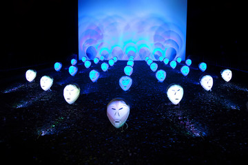 Shining masks of dead pale  crowd