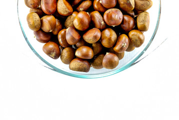 chestnuts in a bowl with empty space on the right are pieces in