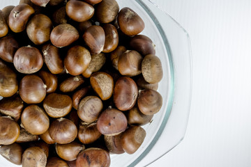 chestnuts in a bowl with empty space on the right are pieces in