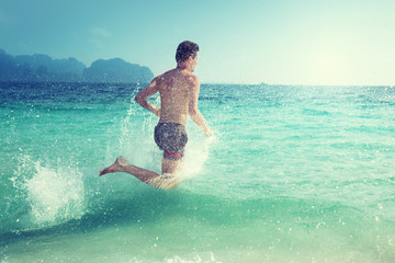 running man in water of tropical sea