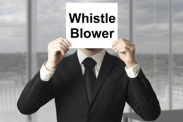 businessman hiding face behind sign whistle blower
